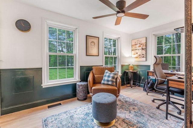 4 Rockwood Ln, Londonderry, NH 03053 - home office featuring plenty of natural light, a wainscoted wall, a ceiling fan, and wood finished floors