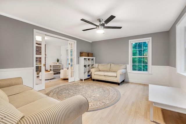 4 Rockwood Ln, Londonderry, NH 03053 - living area with french doors, wood finished floors, ceiling fan, a wainscoted wall, and ornamental molding