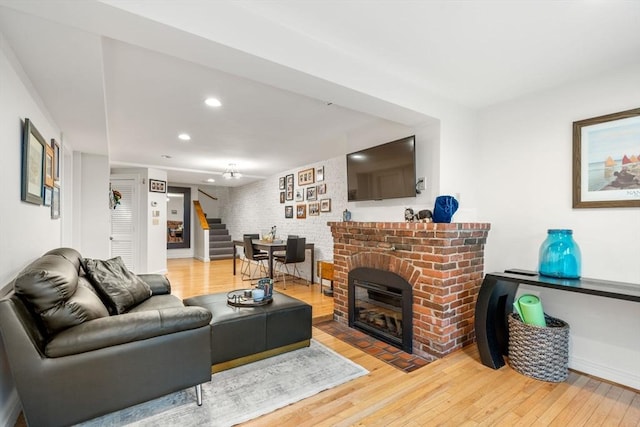 69 Saint Botolph Unit 1, Boston, MA 02116 - living room featuring stairway, wood-type flooring, recessed lighting, and a brick fireplace