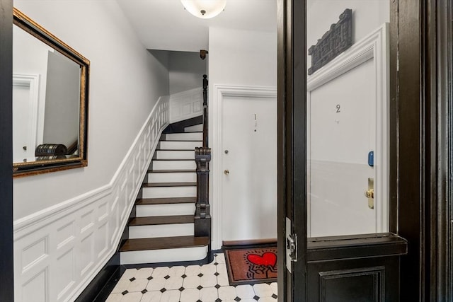 69 Saint Botolph Unit 1, Boston, MA 02116 - stairs featuring tile patterned floors and a wainscoted wall