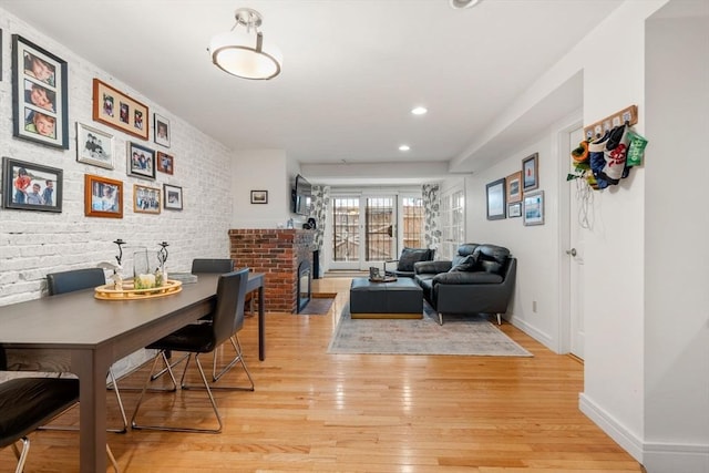 69 Saint Botolph Unit 1, Boston, MA 02116 - dining room with light wood-style flooring, recessed lighting, brick wall, and a fireplace