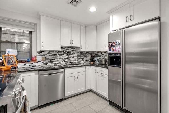 69 Saint Botolph Unit 1, Boston, MA 02116 - kitchen featuring appliances with stainless steel finishes, dark countertops, decorative backsplash, and recessed lighting