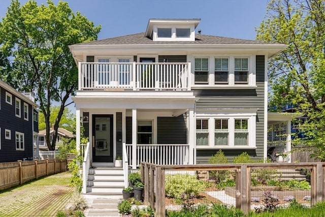 141 Fayerweather St, Cambridge, MA 02138 - american foursquare style home featuring a balcony, a porch, fence, and a shingled roof