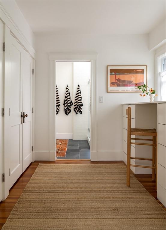 141 Fayerweather St, Cambridge, MA 02138 - hallway with dark wood finished floors and baseboards