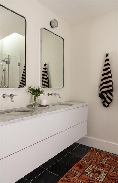 141 Fayerweather St, Cambridge, MA 02138 - full bathroom with double vanity, a stall shower, tile patterned floors, and baseboards