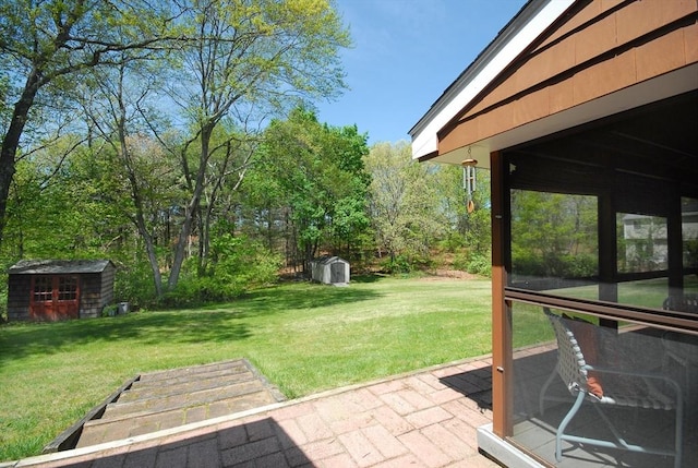 95 Bayberry Rd, Concord, MA 01742 - view of grassy yard featuring a storage shed, a patio area, and an outdoor structure