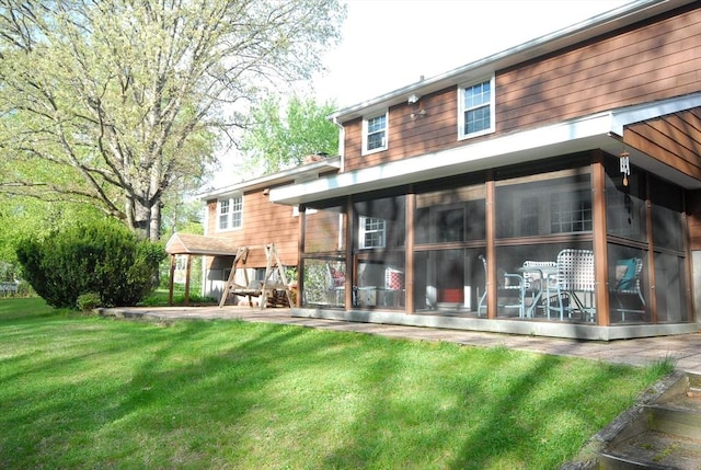 95 Bayberry Rd, Concord, MA 01742 - back of house featuring a sunroom and a lawn