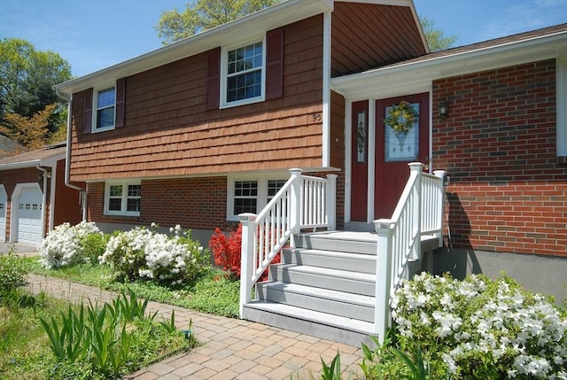 95 Bayberry Rd, Concord, MA 01742 - view of front of home with a garage and brick siding
