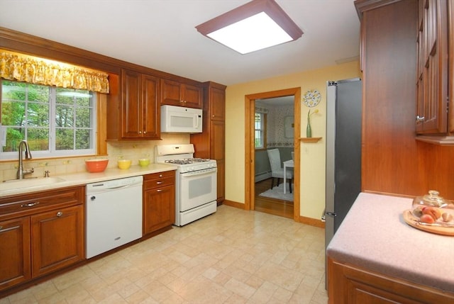 95 Bayberry Rd, Concord, MA 01742 - kitchen with white appliances, a sink, light countertops, and backsplash