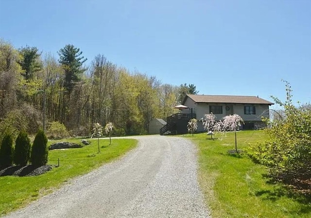 view of road with gravel driveway