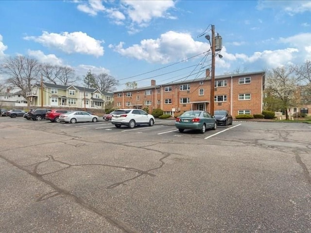 uncovered parking lot with a residential view