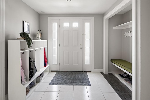 tiled entrance foyer featuring baseboards