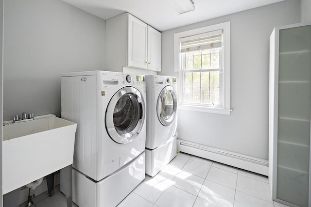 laundry room with washing machine and dryer, a baseboard heating unit, light tile patterned floors, a sink, and cabinet space