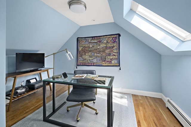 office space featuring lofted ceiling with skylight, baseboards, baseboard heating, and wood finished floors