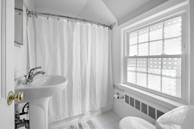 bathroom with tile patterned flooring, toilet, radiator, and shower / bath combo with shower curtain