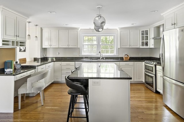 kitchen with white cabinetry, stainless steel appliances, and a sink
