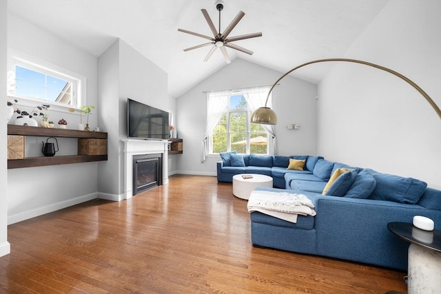 14 Dorset Park Ln, Weymouth, MA 02190 - living room featuring wood finished floors, ceiling fan, vaulted ceiling, a glass covered fireplace, and baseboards
