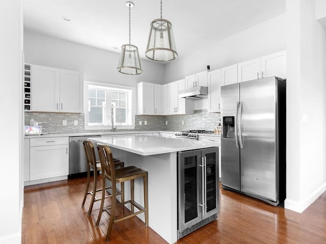 14 Dorset Park Ln, Weymouth, MA 02190 - kitchen with stainless steel appliances, wine cooler, under cabinet range hood, and tasteful backsplash