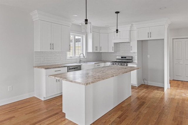 kitchen featuring white cabinets, light countertops, baseboards, and appliances with stainless steel finishes