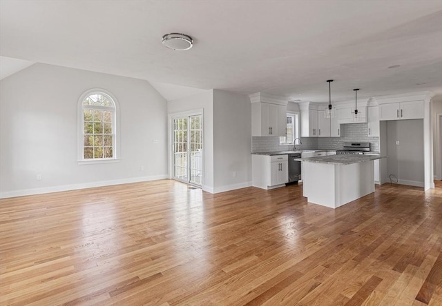 kitchen featuring light wood-style flooring, stainless steel range, dishwashing machine, and white cabinetry