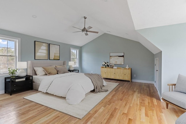 bedroom with lofted ceiling, baseboards, wood finished floors, and ceiling fan