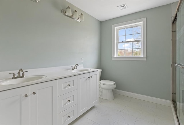 full bathroom with marble finish floor, an enclosed shower, a sink, and visible vents
