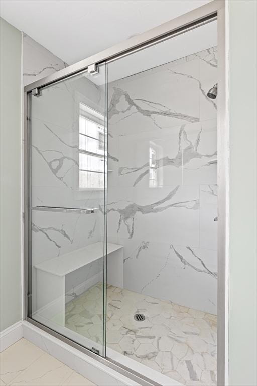 full bath featuring marble finish floor and a marble finish shower