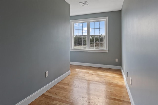 unfurnished room with baseboards, light wood-style flooring, and visible vents