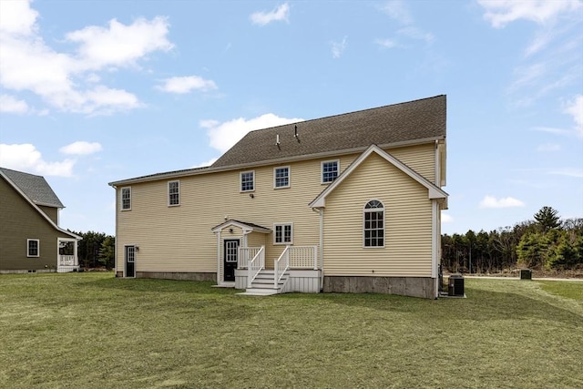 rear view of house featuring a yard and cooling unit