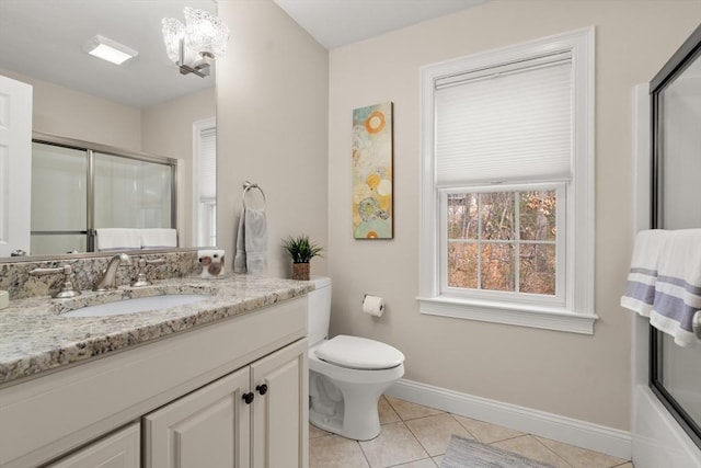 bathroom featuring toilet, a shower with door, tile patterned flooring, baseboards, and vanity