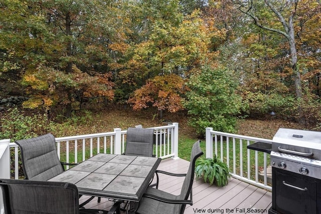 wooden terrace with outdoor dining area