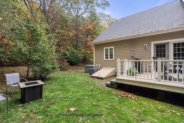 view of yard featuring central AC unit and a deck