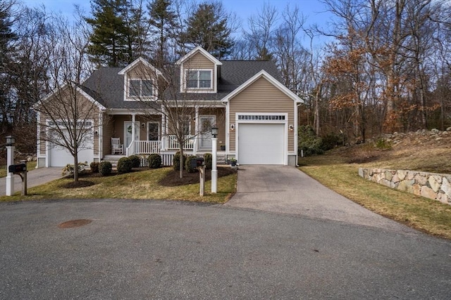 view of front of house featuring an attached garage, covered porch, driveway, and a shingled roof