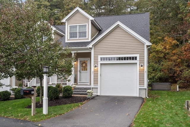 view of front of house featuring a garage, roof with shingles, a front lawn, and aphalt driveway