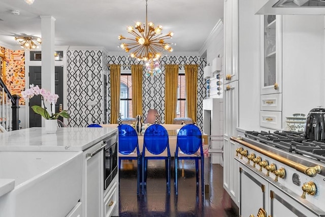 11 Beckler Ave, Boston, MA 02127 - kitchen featuring ornamental molding, white cabinets, a chandelier, appliances with stainless steel finishes, and light countertops