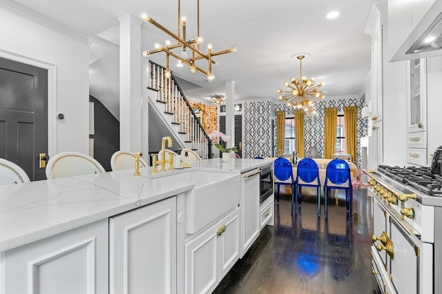11 Beckler Ave, Boston, MA 02127 - kitchen featuring a chandelier, white cabinetry, dark wood-style flooring, pendant lighting, and light stone counters