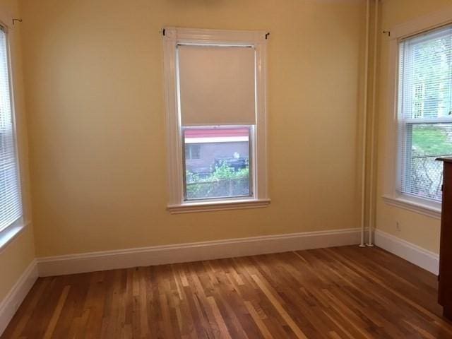 29 Conway St, Boston, MA 02131 - empty room featuring healthy amount of natural light, wood finished floors, and baseboards