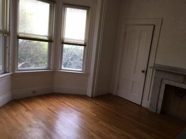 29 Conway St, Boston, MA 02131 - unfurnished living room featuring wood finished floors and a fireplace