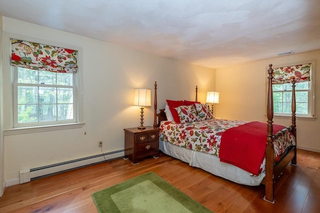 759 Main St, Boxford, MA 01921 - bedroom with a baseboard heating unit and wood finished floors