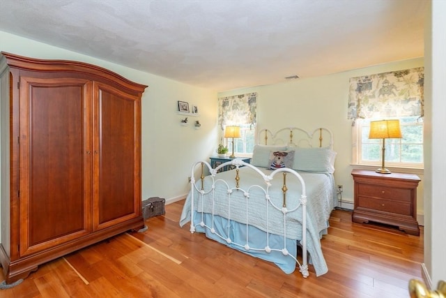759 Main St, Boxford, MA 01921 - bedroom featuring wood finished floors and a baseboard radiator