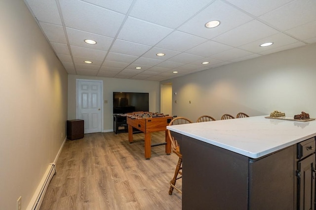 759 Main St, Boxford, MA 01921 - kitchen featuring a baseboard heating unit, a breakfast bar area, light countertops, light wood finished floors, and recessed lighting