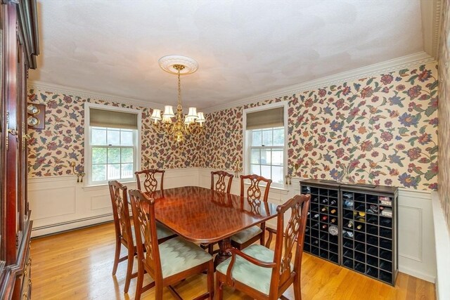 759 Main St, Boxford, MA 01921 - dining area with wallpapered walls, a baseboard heating unit, healthy amount of natural light, wainscoting, and crown molding
