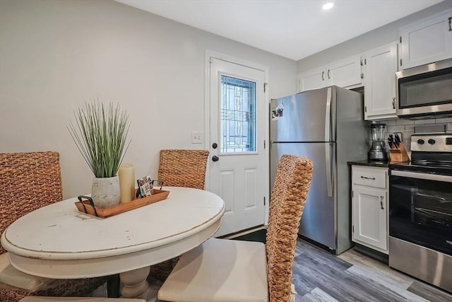 dining area with wood-type flooring