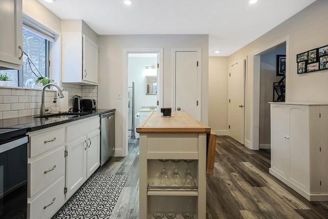 kitchen with sink, dishwasher, white cabinets, and stove