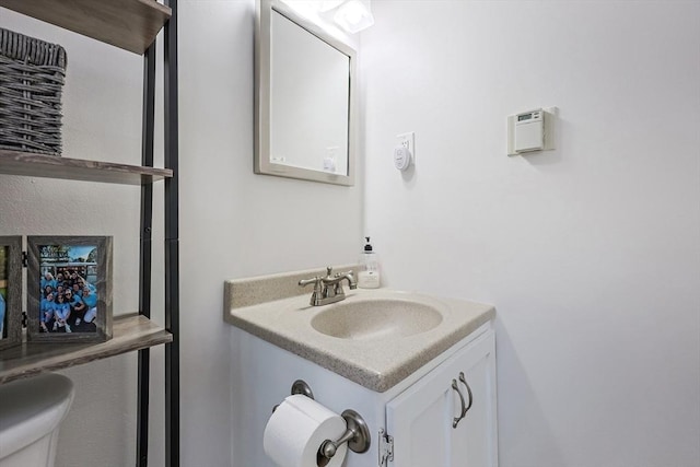 bathroom featuring toilet and vanity