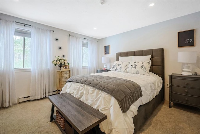 carpeted bedroom with a baseboard heating unit