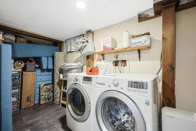 clothes washing area with washer and clothes dryer