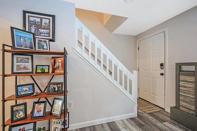 stairs featuring hardwood / wood-style floors