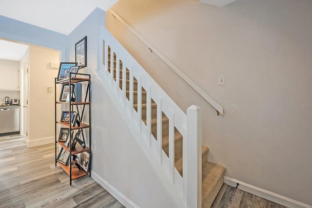 stairs featuring hardwood / wood-style flooring