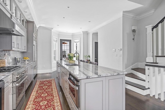 795 E 4th St, Boston, MA 02127 - kitchen featuring a sink, appliances with stainless steel finishes, under cabinet range hood, dark wood finished floors, and a large island
